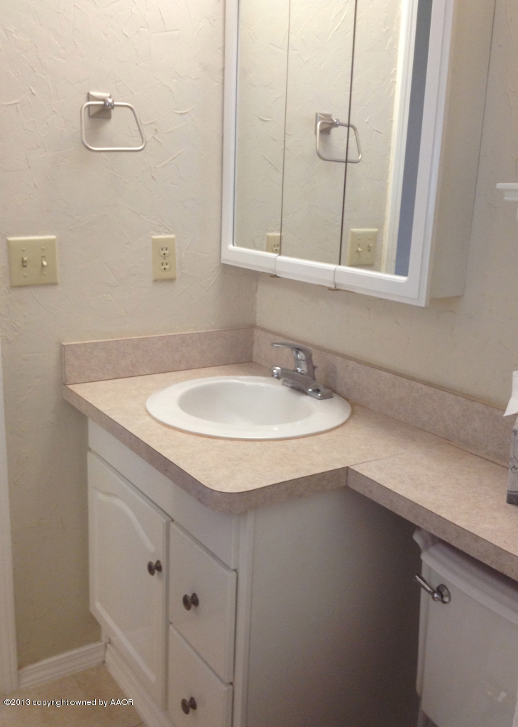 8213 Goodnight Trail Amarillo, TX 79110 - Photo 17 of 20 a bathroom with a sink and a mirror