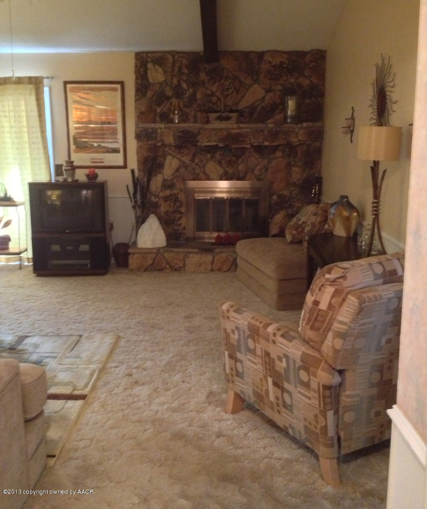 8213 Goodnight Trail Amarillo, TX 79110 - Photo 3 of 20 a living room with furniture and a fireplace