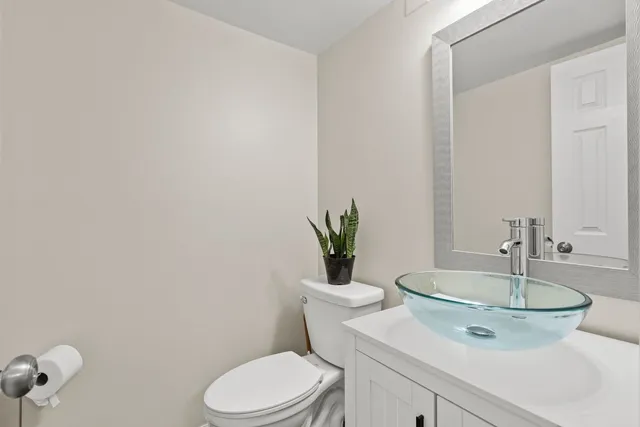 a bathroom with a toilet a sink and mirror