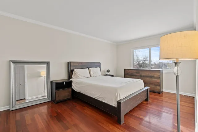 a bedroom with a bed and a lamp on table