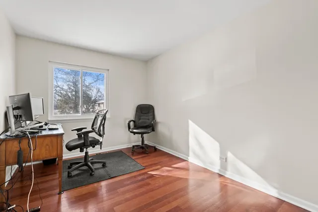a view of a workspace with furniture and a window