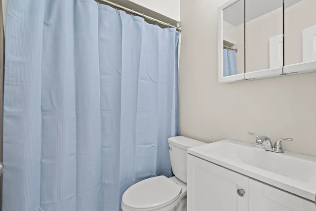 a white toilet sitting next to a bathroom sink