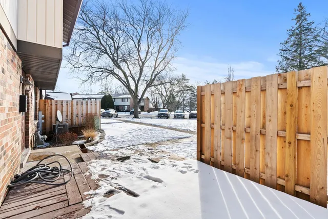 a view of a backyard with wooden fence