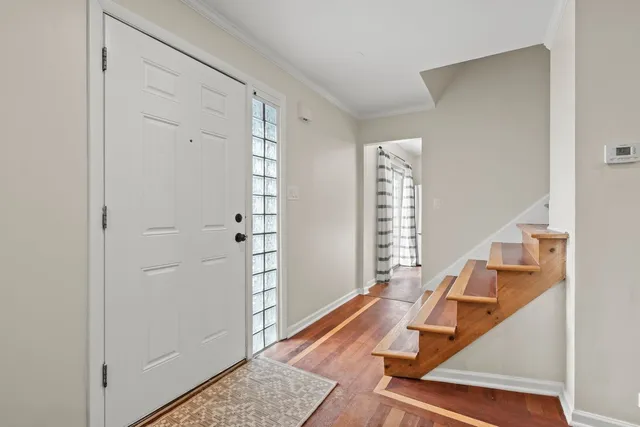a room with wooden floor and windows