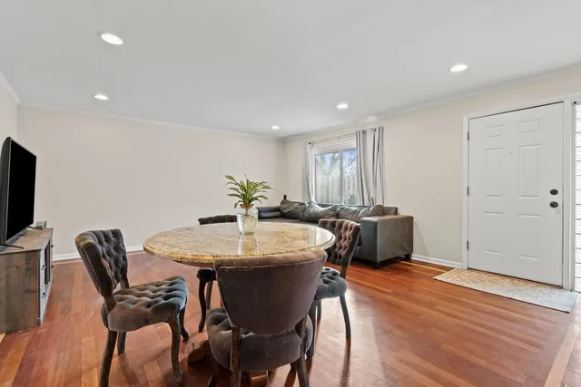 a view of a dining room with furniture and wooden floor