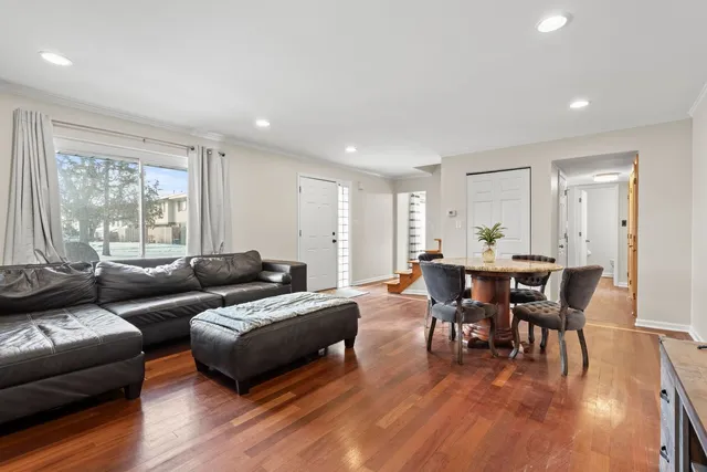 a living room with furniture and a wooden floor