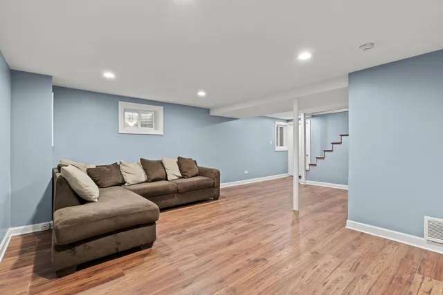 a living room with furniture and a wooden floor