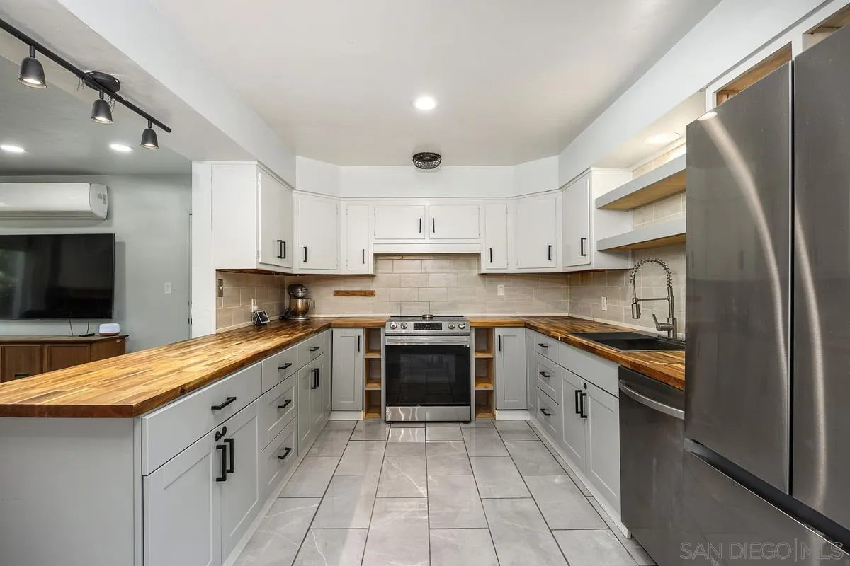 1211 East Mission Road Fallbrook, CA 92028 - Photo 11 of 31 a kitchen with stainless steel appliances granite countertop a stove a sink and a refrigerator