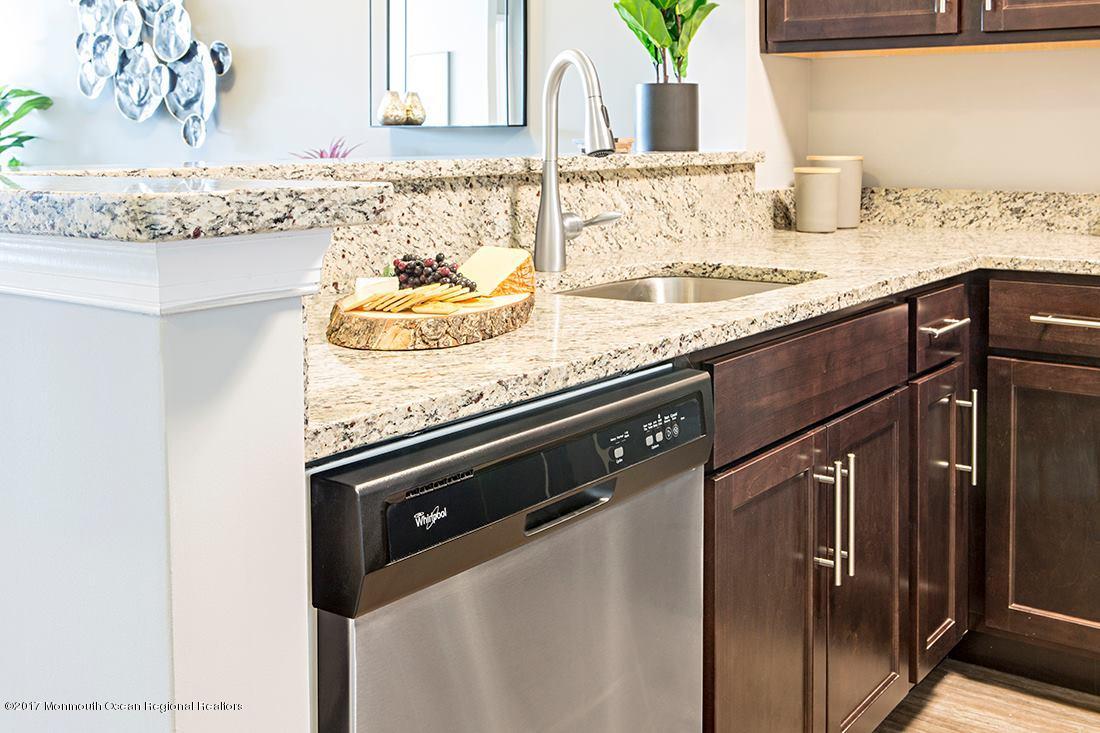 249 Broad Street, Unit 322 Matawan, NJ 07747 - Photo 9 of 27 a kitchen with granite countertop stainless steel appliances and sink