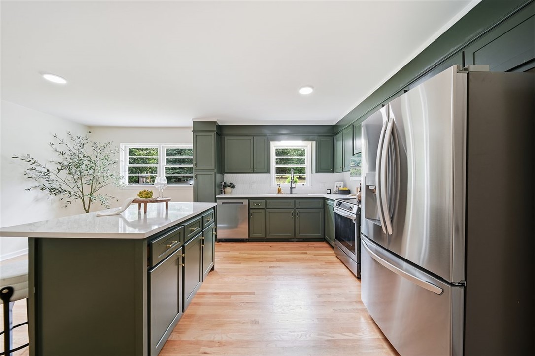 107 Edwards Mill Road Taylors, SC 29687 - Photo 7 of 34 A well-appointed kitchen features stainless steel appliances, abundant cabinetry, and a central island.