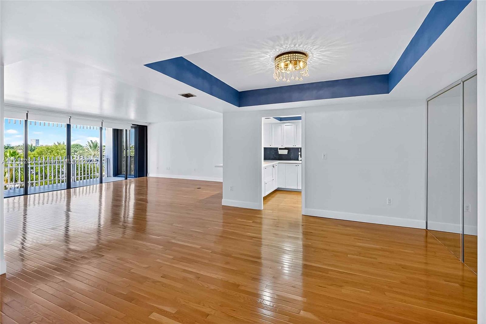 2 Grove Isle Drive, Unit B404 Coconut Grove, FL 33133 - Photo 1 of 36 a view of empty room with wooden floor and fan