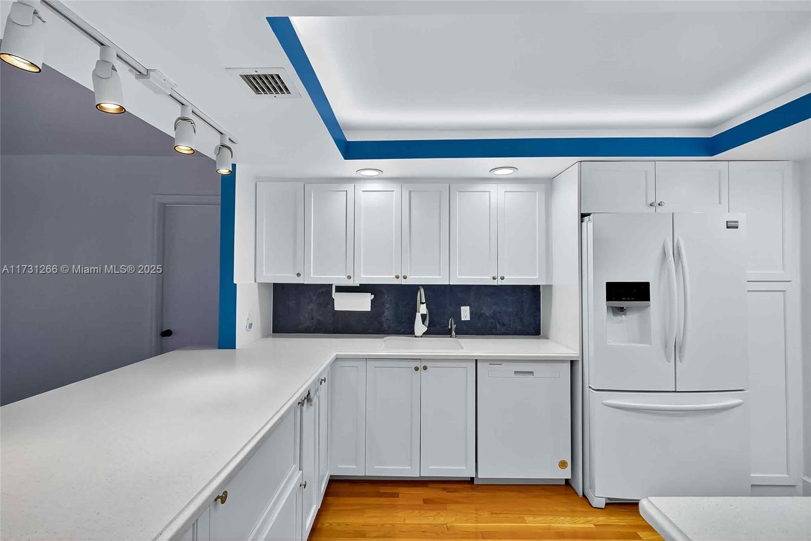 2 Grove Isle Drive, Unit B404 Coconut Grove, FL 33133 - Photo 13 of 36 a kitchen with a cabinets and white appliances