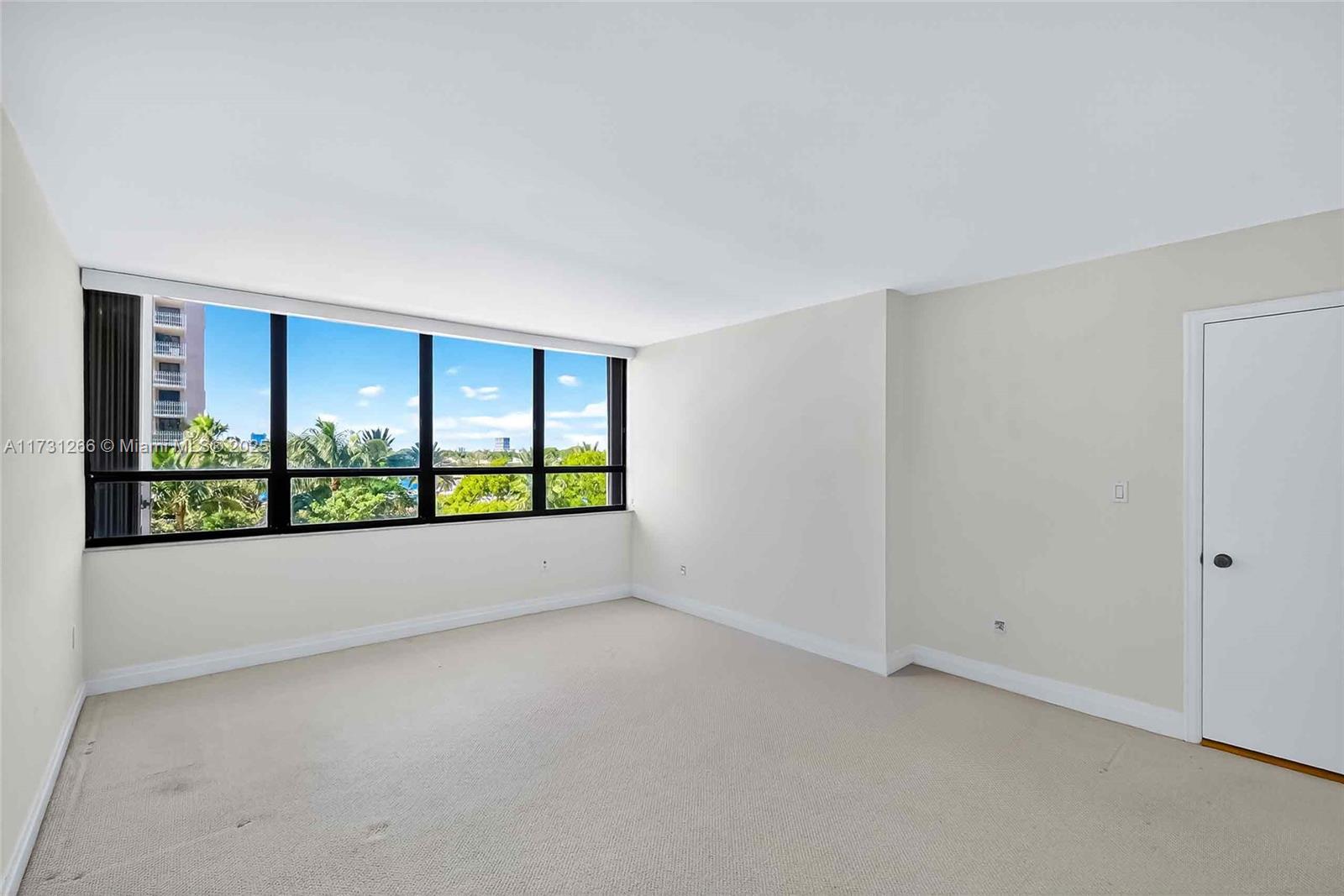 2 Grove Isle Drive, Unit B404 Coconut Grove, FL 33133 - Photo 23 of 36 a view of an empty room with a window