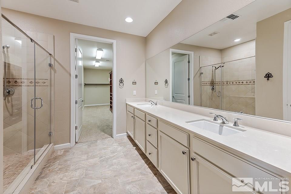 2220 Trakehner Lane Reno, NV 89521 - Photo 13 of 25 a spacious bathroom with a shower sink and mirror