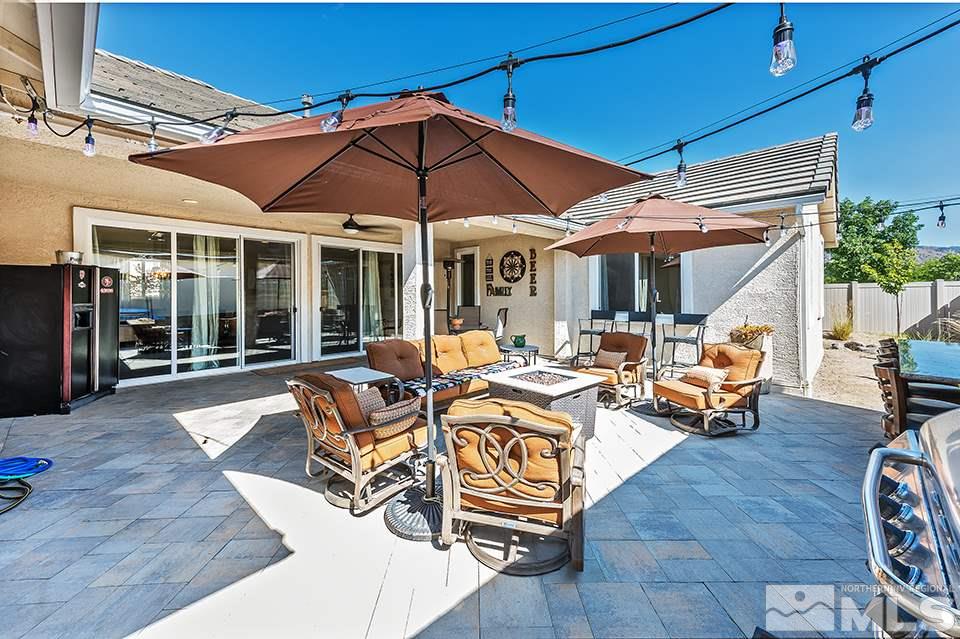 2220 Trakehner Lane Reno, NV 89521 - Photo 16 of 25 a view of a patio with table and chairs under an umbrella