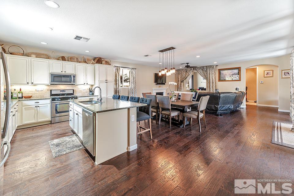 2220 Trakehner Lane Reno, NV 89521 - Photo 2 of 25 a living room with stainless steel appliances granite countertop furniture wooden floor and a view of kitchen