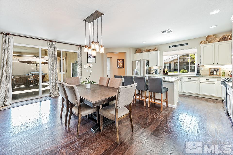 2220 Trakehner Lane Reno, NV 89521 - Photo 5 of 25 a view of a dining room with furniture window and wooden floor