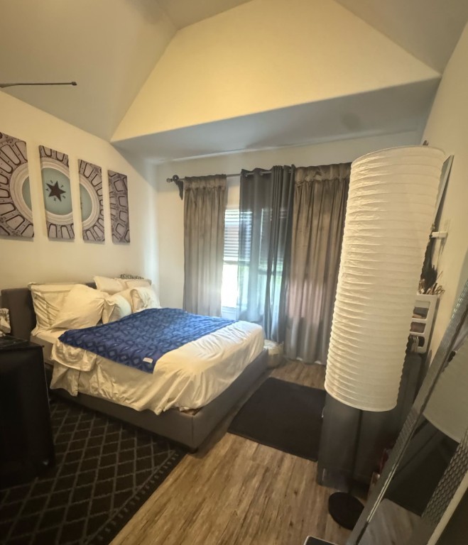 3223 Real Street, Unit B Houston, TX 77087 - Photo 3 of 6 a bedroom with a bed and wooden floor