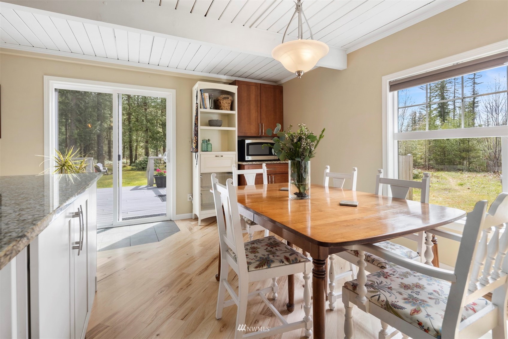 7688 Silver Lake Road Maple Falls, WA 98266 - Photo 14 of 40 a dining room with furniture a chandelier and wooden floor