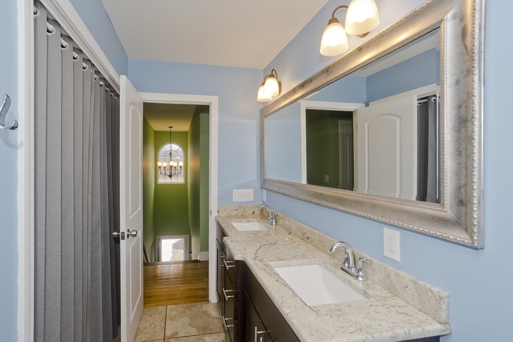 48 Mountain Avenue West Springfield, MA 01089 - Photo 26 of 39 a bathroom with a sink a mirror and a shower