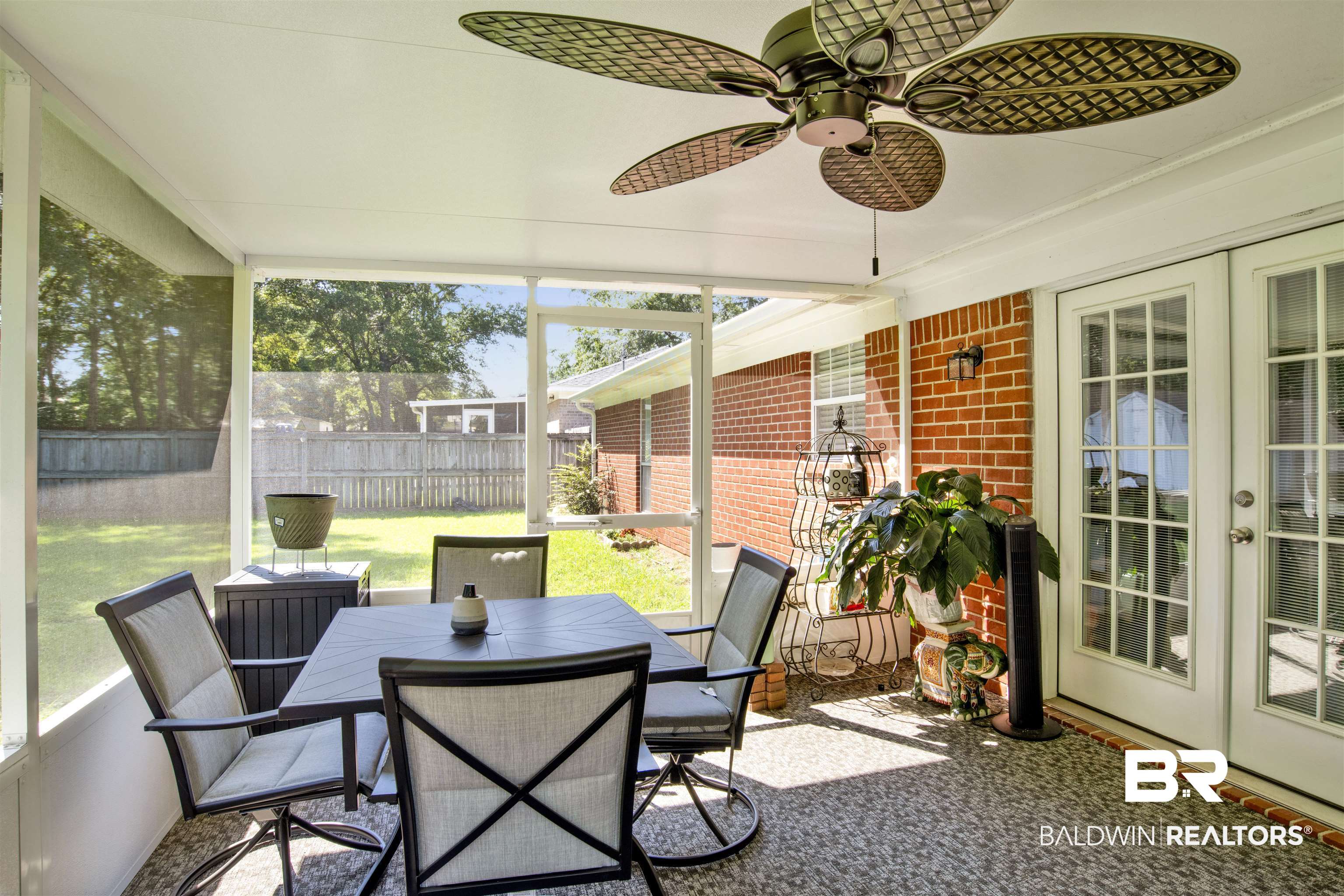 6281 Woodside Drive Theodore, AL 36582 - Photo 17 of 17 Sunroom / solarium with french doors, ceiling fan, and outdoor dining space