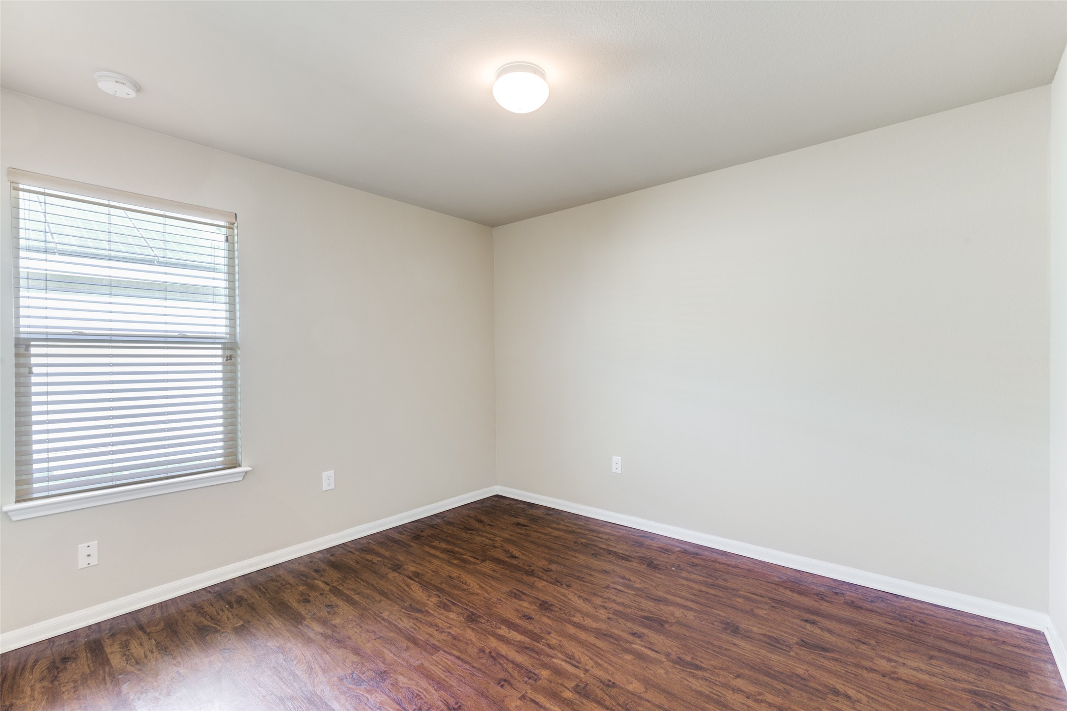 801 Silver Wing Drive Austin, TX 78725 - Photo 18 of 29 an empty room with wooden floor and windows