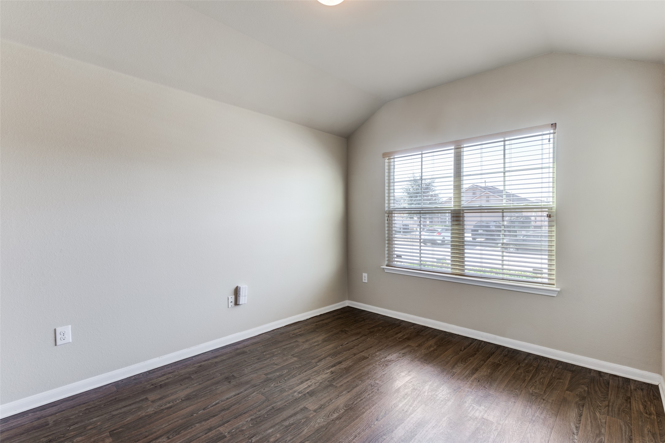 801 Silver Wing Drive Austin, TX 78725 - Photo 4 of 29 a view of an empty room with wooden floor and a window