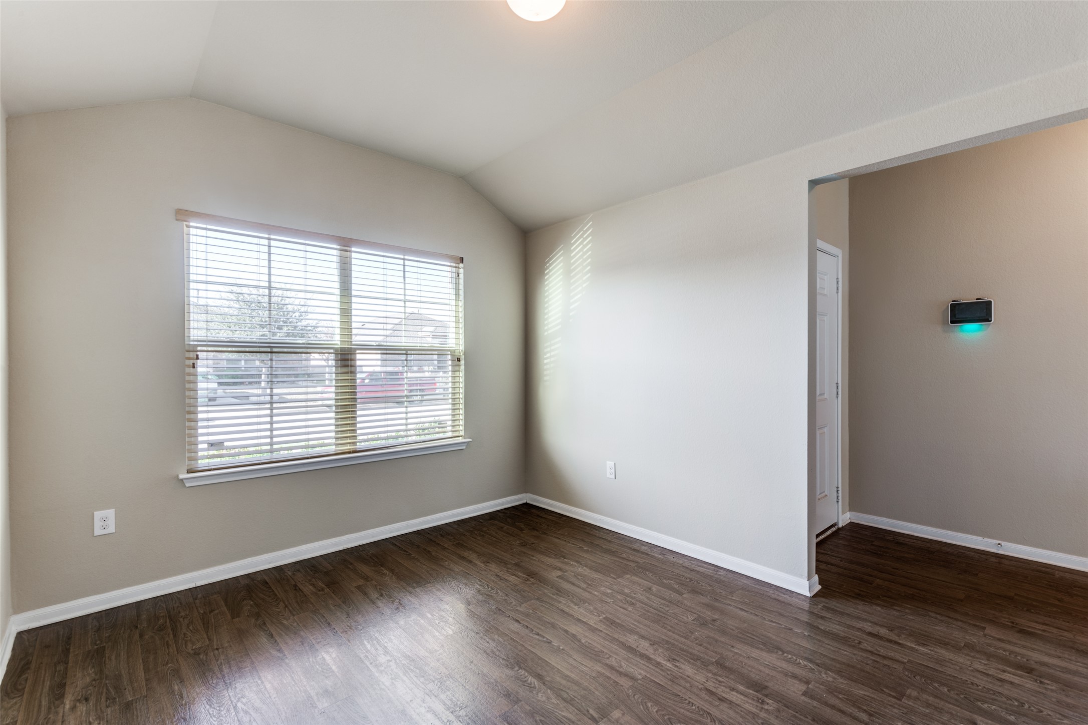 801 Silver Wing Drive Austin, TX 78725 - Photo 5 of 29 an empty room with wooden floor and windows