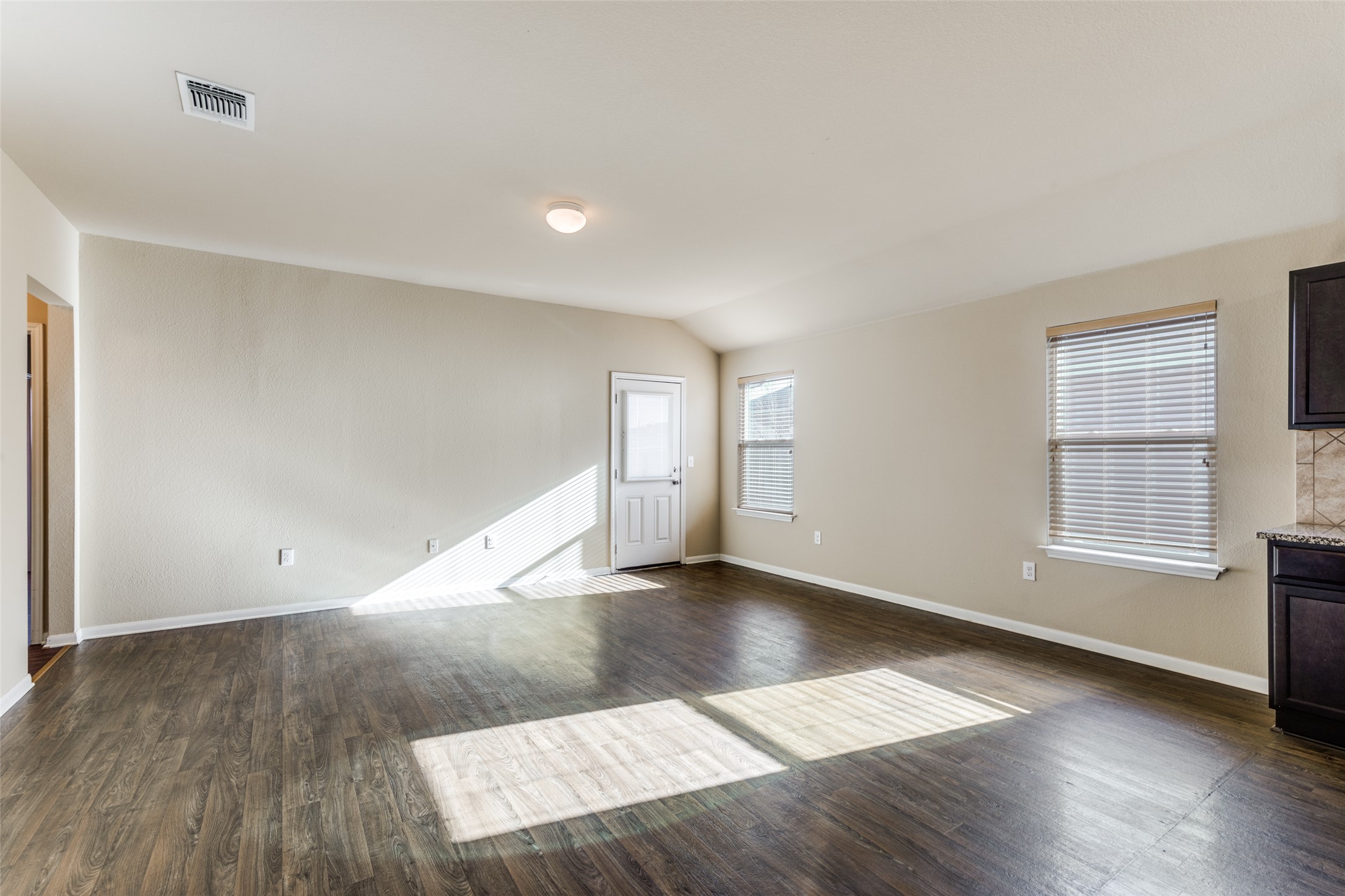 801 Silver Wing Drive Austin, TX 78725 - Photo 8 of 29 an empty room with wooden floor and windows