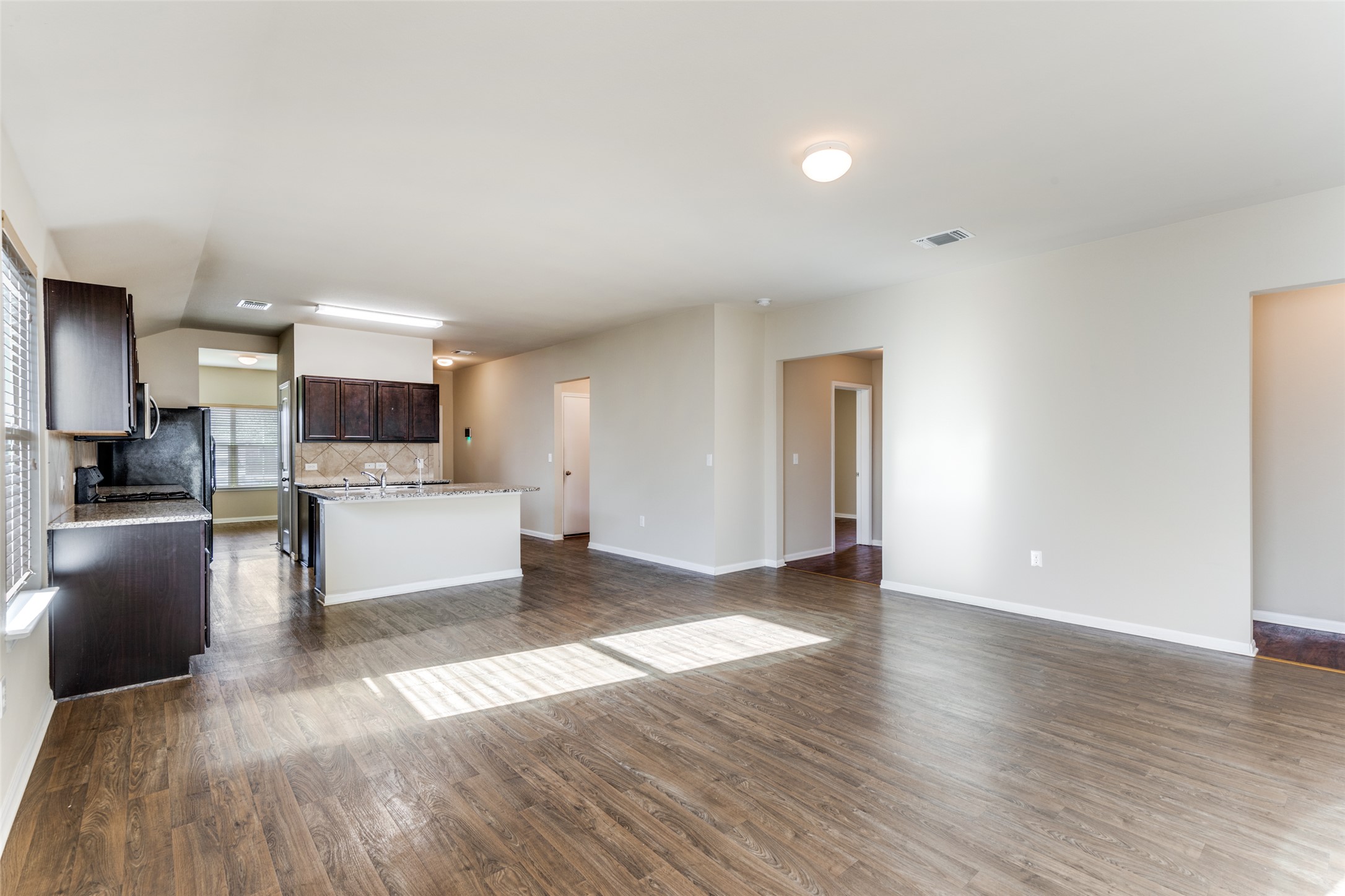 801 Silver Wing Drive Austin, TX 78725 - Photo 28 of 29 a view of a kitchen with furniture and wooden floor