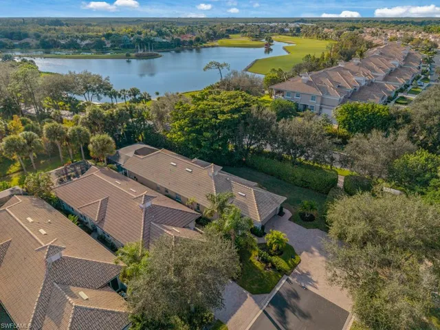 an aerial view of house with yard and lake view