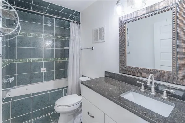 a kitchen with stainless steel appliances granite countertop a sink and a refrigerator