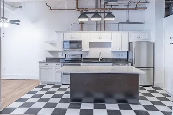 a kitchen with stainless steel appliances a stove a sink and a refrigerator