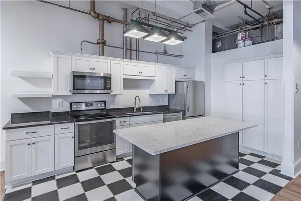 a hallway with black and white cabinets