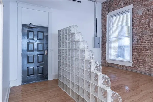 a view of wooden floor and entryway in a room