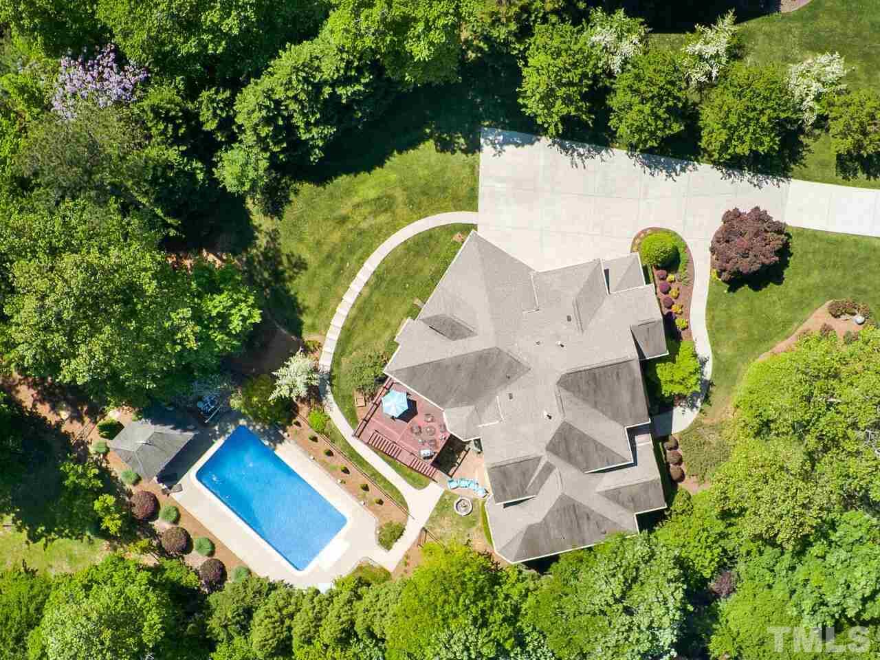 an aerial view of a house with outdoor space and tennis court