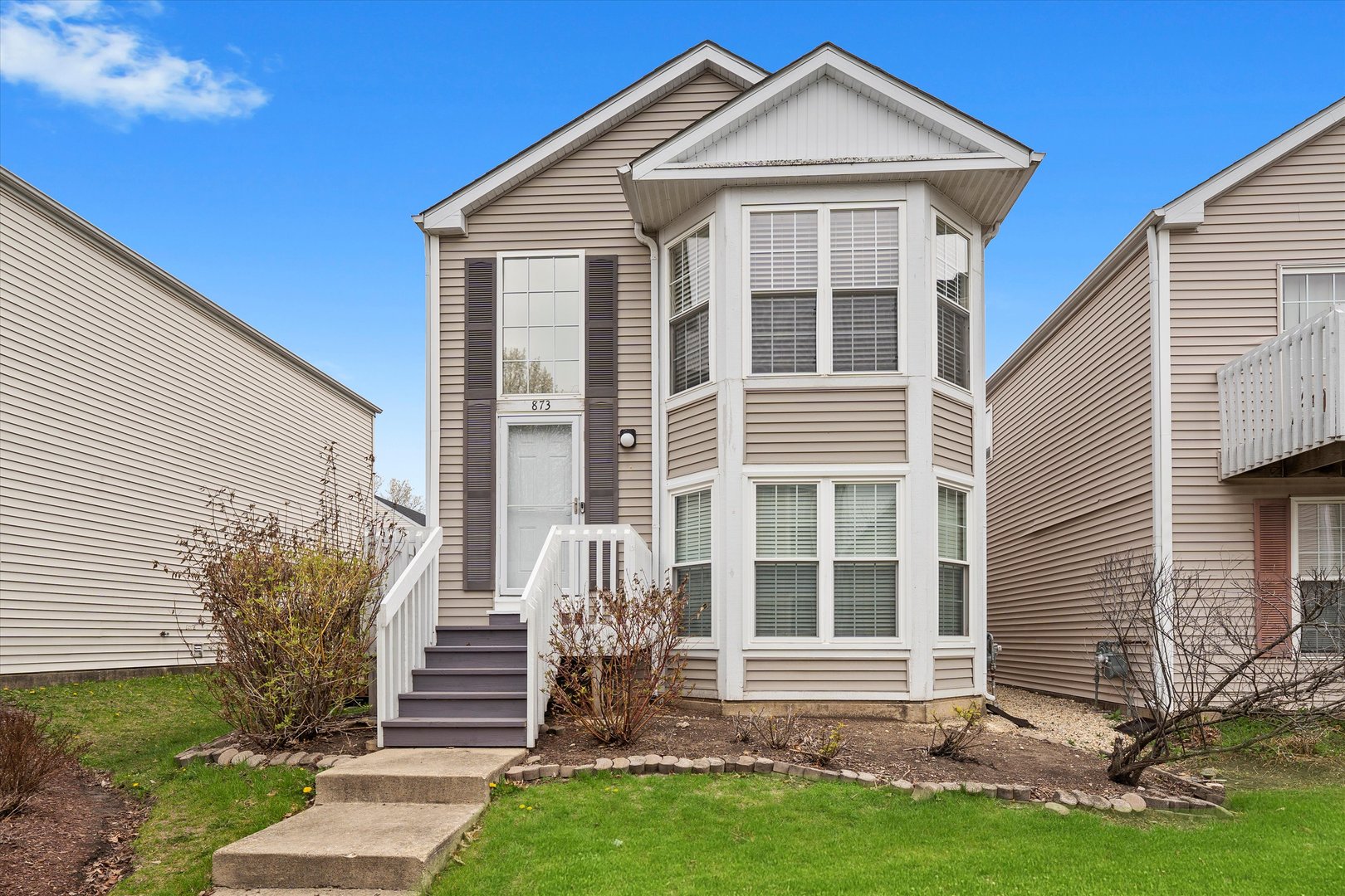 873 Symphony Drive Aurora, IL 60504 - Photo 2 of 24 a front view of a house with a yard