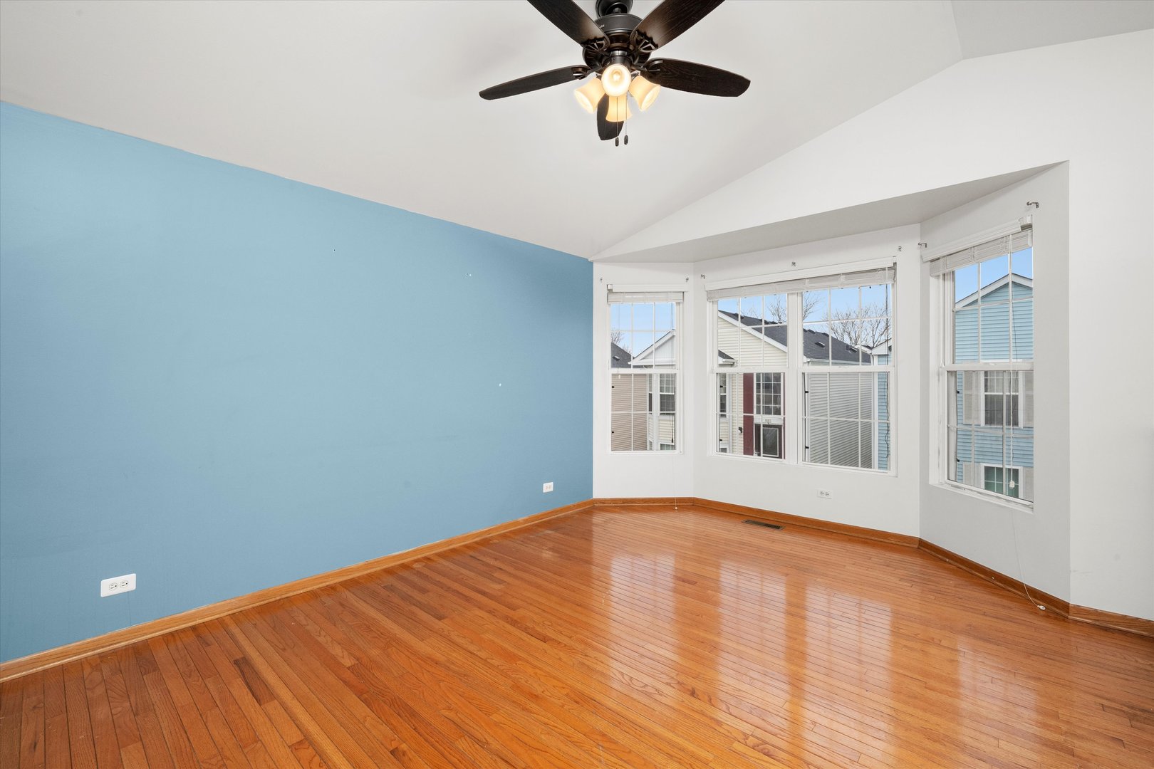 873 Symphony Drive Aurora, IL 60504 - Photo 4 of 24 a view of empty room with wooden floor and fan