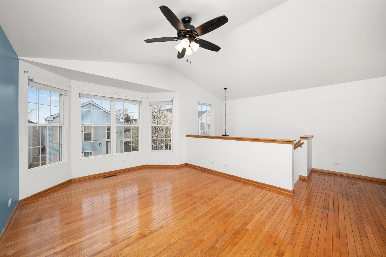 873 Symphony Drive Aurora, IL 60504 - Photo 5 of 24 a view of an empty room with a window and wooden floor