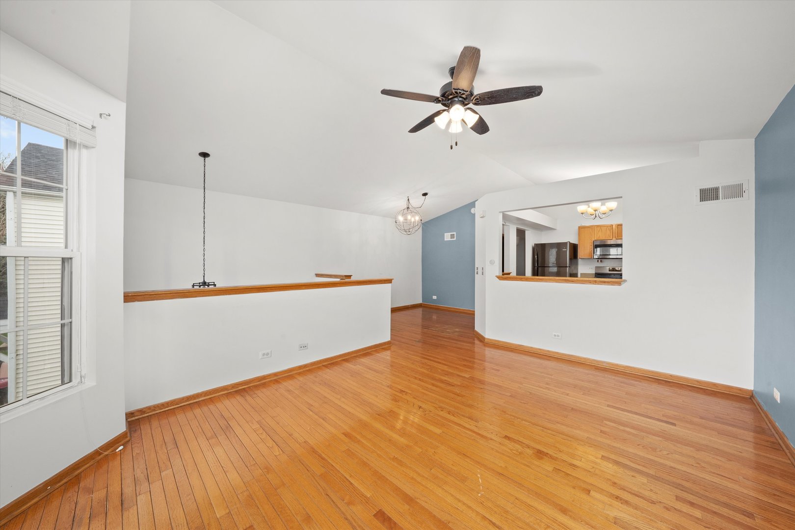 873 Symphony Drive Aurora, IL 60504 - Photo 6 of 24 a view of a room with wooden floor and white walls