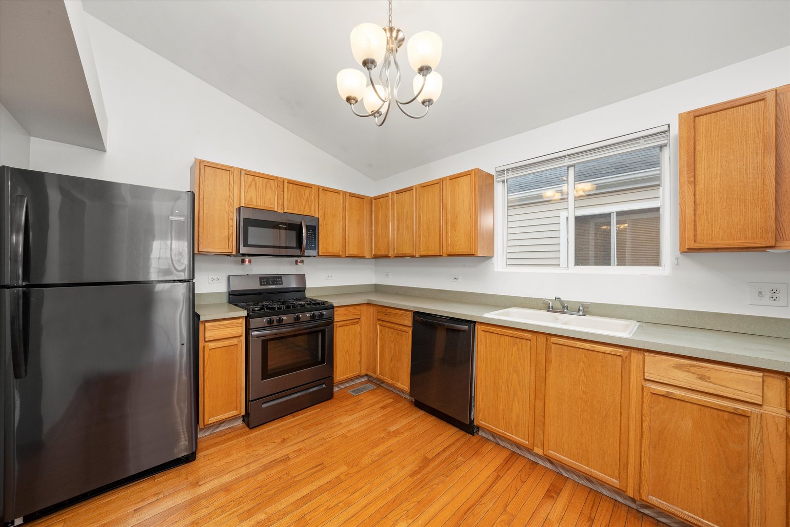 873 Symphony Drive Aurora, IL 60504 - Photo 7 of 24 a kitchen with stainless steel appliances granite countertop a refrigerator a stove top oven a sink and dishwasher