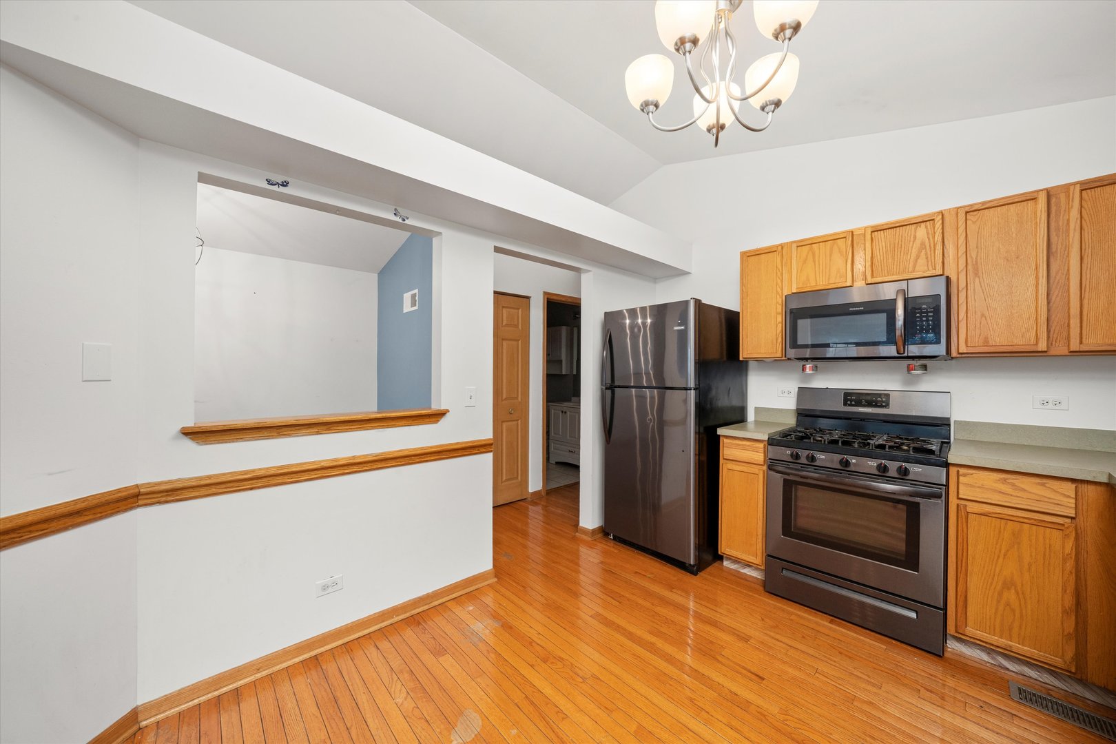 873 Symphony Drive Aurora, IL 60504 - Photo 8 of 24 a kitchen with stainless steel appliances granite countertop a refrigerator and a stove top oven