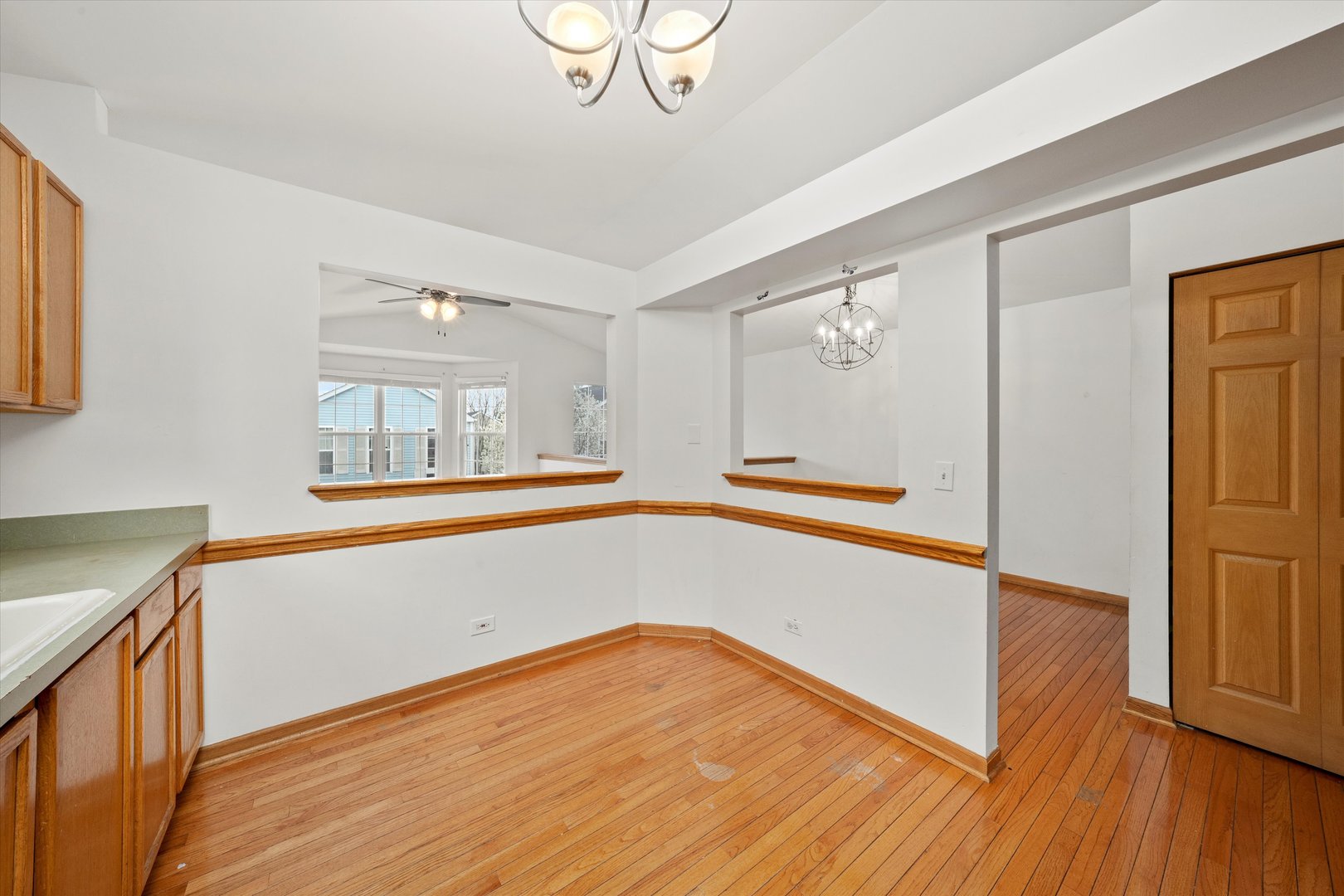 873 Symphony Drive Aurora, IL 60504 - Photo 9 of 24 a view of empty room with wooden floor and fan