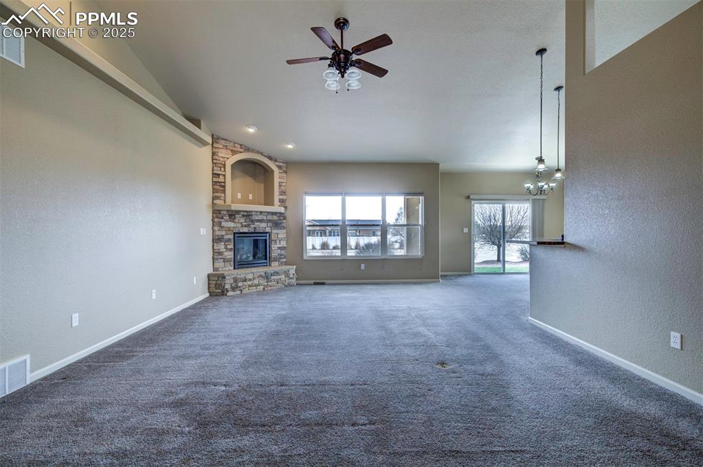 24484 Gale Road Pueblo, CO 81006 - Photo 13 of 43 en view interior of a house with a fireplace and windows