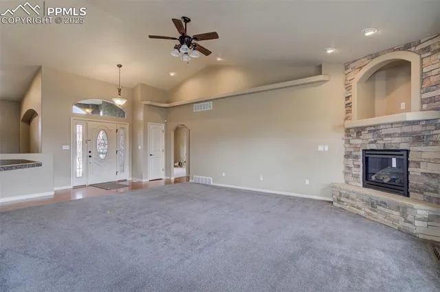 a view of an empty room with a fireplace