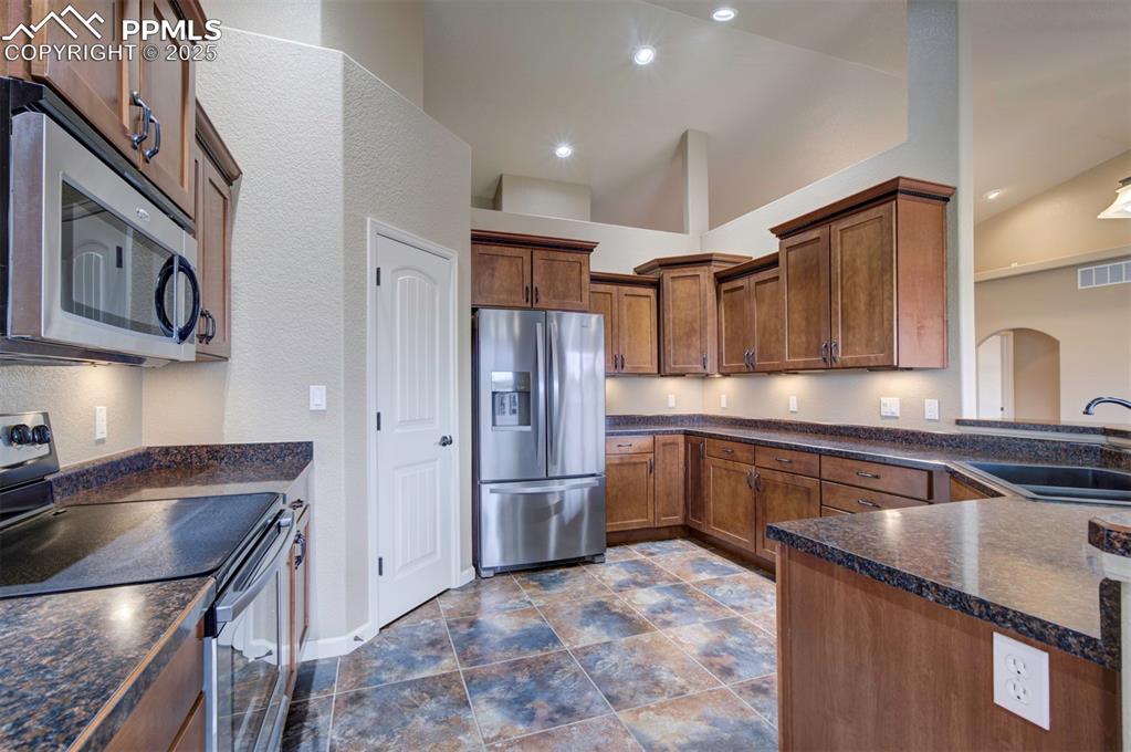 24484 Gale Road Pueblo, CO 81006 - Photo 20 of 43 a kitchen with stainless steel appliances granite countertop a sink refrigerator and cabinets