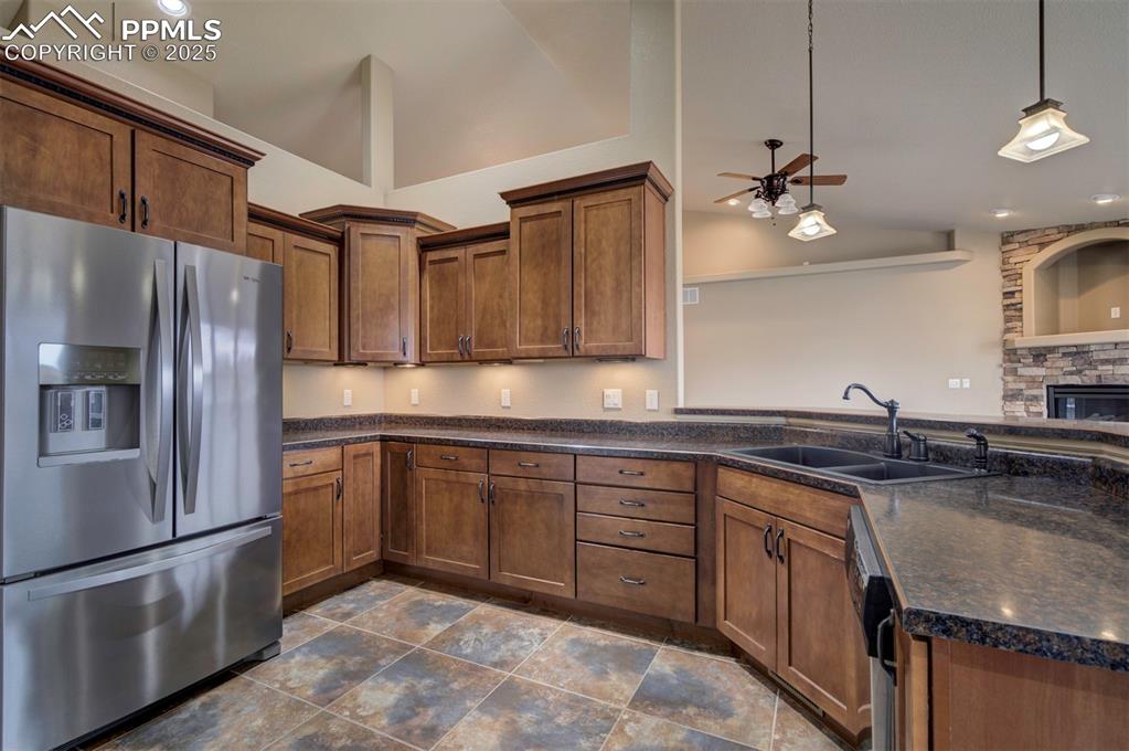 24484 Gale Road Pueblo, CO 81006 - Photo 23 of 43 a kitchen with stainless steel appliances granite countertop a sink stove and refrigerator