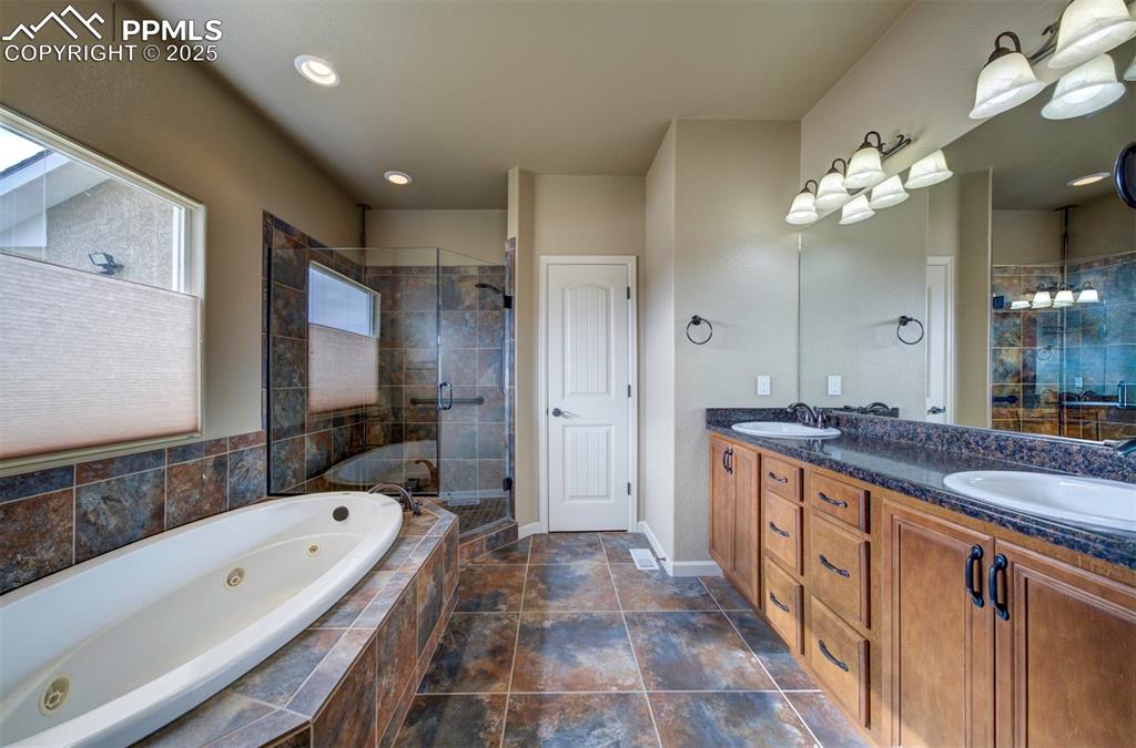 24484 Gale Road Pueblo, CO 81006 - Photo 28 of 43 a spacious bathroom with a granite countertop tub sink shower and mirror