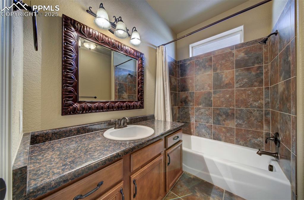 24484 Gale Road Pueblo, CO 81006 - Photo 36 of 43 a bathroom with a granite countertop sink mirror and bathtub