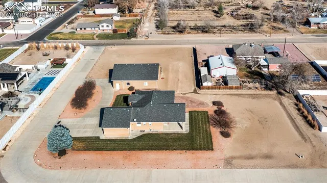 an aerial view of a house with a yard